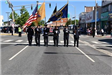Honor Guard Marching in the Street with Flags