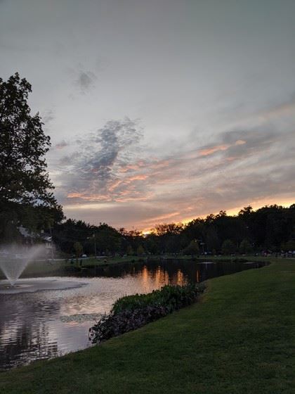 Dusk over a Park Fountain in a Pond